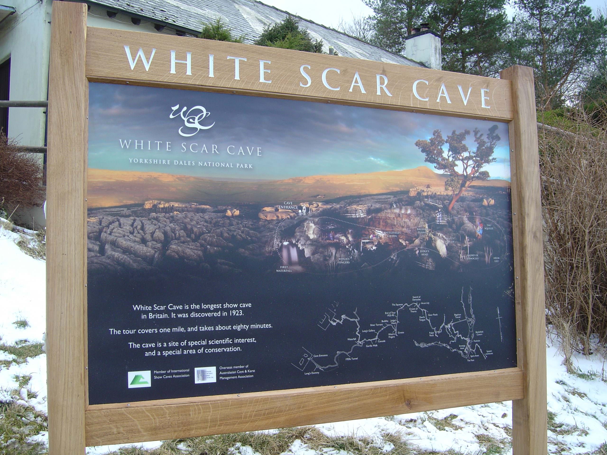 Visitor attraction entrance sign with routed oak wood header panel, lettering paintedpanel;