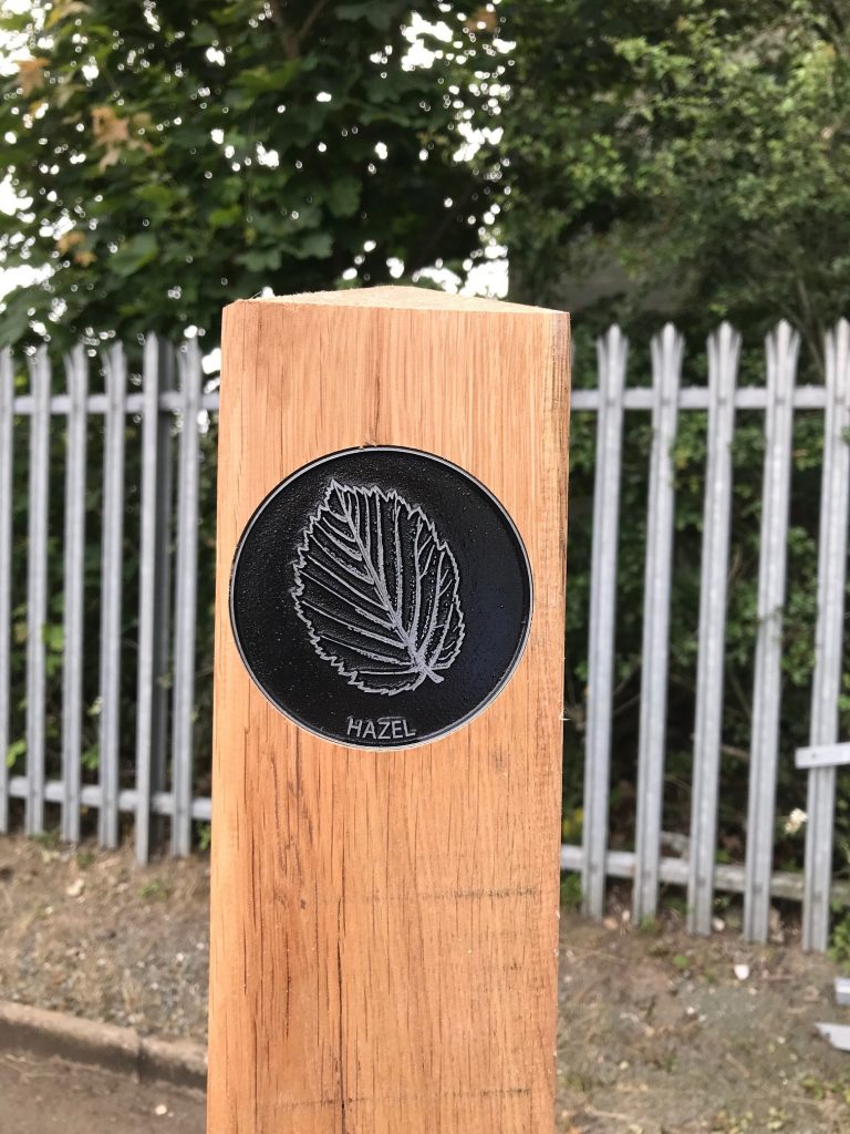 Zinc etched waymarker disc in an oak post